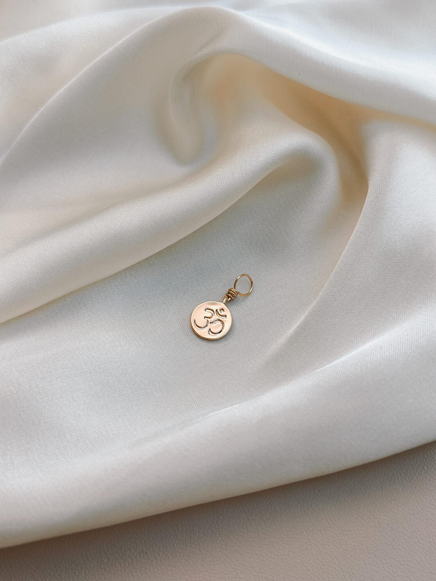 OM 🕉️ Der Urklang des Universums. OM ist mehr als ein Symbol. Es ist ein Klang, eine Schwingung, ein Anfang. In ihm liegt die Erinnerung an die Verbindung mit allem, was ist – eine Rückkehr in die Stille, in die Einheit. Der Anhänger OM begleitet dich als täglicher Anker für Achtsamkeit, Balance und Bewusstsein. Eine Einladung, innezuhalten, zu spüren, zu sein. Ob in der Meditation, beim Atmen oder einfach im Alltag – das Zeichen OM hilft dir, dich zu erinnern: Alles ist eins. Und du bist genau jetzt genau richtig. ✨ Bedeutung von OM: Schöpfung & Einheit: OM steht für den Ursprung von allem – verbunden mit allem, was ist Achtsamkeit & Präsenz: Der Klang bringt dich ins Jetzt, zurück in deinen Körper Spirituelle Tiefe: OM öffnet das Tor zu innerem Wachstum und höheren Bewusstseinsebenen Balance & Harmonie: Die Schwingung wirkt beruhigend und stärkend auf Körper und Seele Stille & Zentrierung: Ein Symbol für inneren Frieden und Klarheit 🕊️ Affirmation: „Ich bin verbunden mit dem Urklang des Lebens – ruhig, klar und getragen.“ Details zum Schmuck Material: Messing 18K Vergoldet  Größe: 12 mm x 9 mm und mit einer stabilen Öse aus vergoldetem Kupferdraht versehen. Der Anhänger passt zu deiner YOUR.line Kette Ein kleiner Begleiter mit großer Bedeutung – minimalistisch, zeitlos und voller Kraft. 🤍 Lieferumfang: nur Anhänger