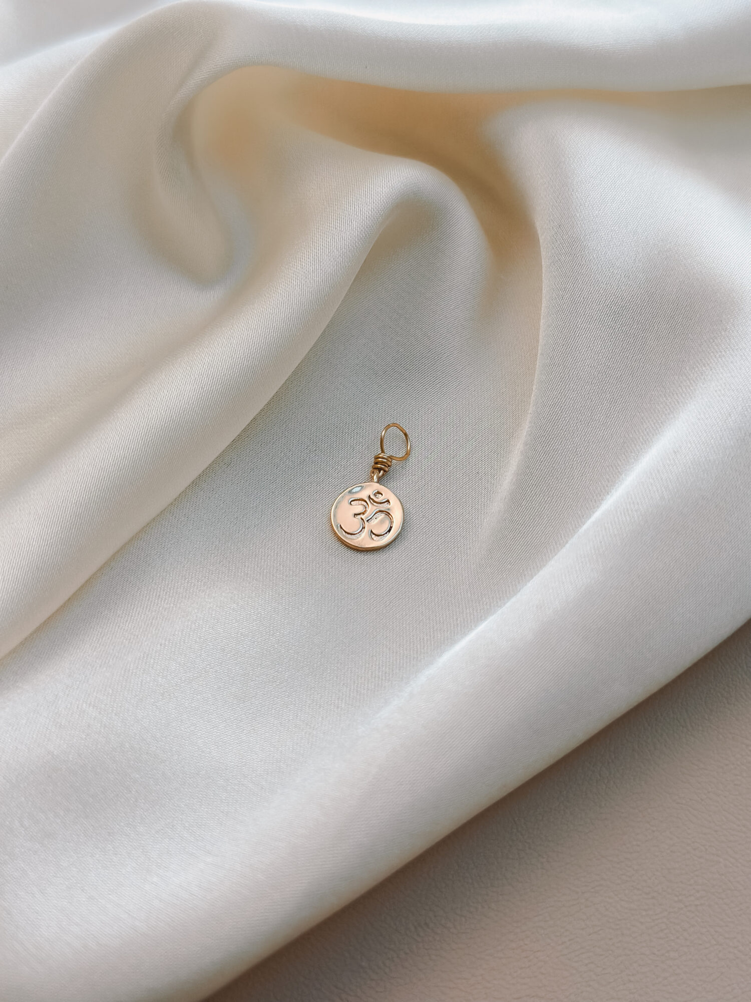 OM 🕉️ Der Urklang des Universums. OM ist mehr als ein Symbol. Es ist ein Klang, eine Schwingung, ein Anfang. In ihm liegt die Erinnerung an die Verbindung mit allem, was ist – eine Rückkehr in die Stille, in die Einheit. Der Anhänger OM begleitet dich als täglicher Anker für Achtsamkeit, Balance und Bewusstsein. Eine Einladung, innezuhalten, zu spüren, zu sein. Ob in der Meditation, beim Atmen oder einfach im Alltag – das Zeichen OM hilft dir, dich zu erinnern: Alles ist eins. Und du bist genau jetzt genau richtig. ✨ Bedeutung von OM: Schöpfung & Einheit: OM steht für den Ursprung von allem – verbunden mit allem, was ist Achtsamkeit & Präsenz: Der Klang bringt dich ins Jetzt, zurück in deinen Körper Spirituelle Tiefe: OM öffnet das Tor zu innerem Wachstum und höheren Bewusstseinsebenen Balance & Harmonie: Die Schwingung wirkt beruhigend und stärkend auf Körper und Seele Stille & Zentrierung: Ein Symbol für inneren Frieden und Klarheit 🕊️ Affirmation: „Ich bin verbunden mit dem Urklang des Lebens – ruhig, klar und getragen.“ Details zum Schmuck Material: Messing 18K Vergoldet  Größe: 12 mm x 9 mm und mit einer stabilen Öse aus vergoldetem Kupferdraht versehen. Der Anhänger passt zu deiner YOUR.line Kette Ein kleiner Begleiter mit großer Bedeutung – minimalistisch, zeitlos und voller Kraft. 🤍 Lieferumfang: nur Anhänger