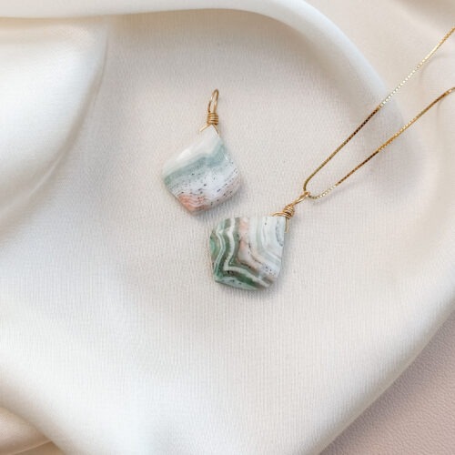 Andenopal – Der Edelstein der Sanftheit und Herzöffnung Ich öffne mein Herz für das, was leicht und wahr ist. Der Andenopal ist ein besonders sanfter Begleiter – ein Edelstein, der in Peru geborgen wird und in vielen zarten Farben vorkommt: Rosa, Mint, Hellblau, Beige oder fast transparente Weißtöne. Diese natürliche Farbvielfalt entsteht durch feinste mineralische Einschlüsse und macht jeden Stein einzigartig. Seine Energie wirkt wie ein weicher Atemzug: beruhigend, lösend, öffnend. Der Andenopal unterstützt dich dabei, emotional weicher zu werden, alte Anspannung loszulassen und dich selbst liebevoll anzunehmen. Er stärkt deine Sensibilität, ohne dich zu überfluten, und lädt dich ein, dein Herz wieder vertrauensvoll zu öffnen. ✨Themen Mental: Emotionale Öffnung, Weichheit, Verletzlichkeit zulassen, Selbstannahme, innere Heilung, Sensibilität, Empathie, Herzenergie, Bewegung, Natürlichkeit, Achtsamkeit Körper: Herzraum, Stressregulation, Atemwege, Haut, emotionale Verspannungen Chakra: Herzchakra Planet: Venus Element: Wasser Sternzeichen: Stier, Krebs, Waage, Fische 🗿Mineralogische & historische Fakten Andenopal ist ein wasserhaltiges Silikat, das ausschließlich in Peru vorkommt. Er gehört mineralogisch zur Familie der Opale, allerdings ohne das typische Farbspiel. Seine pastelligen Rosa-, Grün-, Blau- und Cremetöne entstehen durch Spurenelemente und natürliche Einlagerungen im Stein. Traditionell wird Andenopal in den peruanischen Anden als Stein des Herzens genutzt – für Frieden, emotionale Heilung und innere Weichheit. Er galt als Begleiter für Menschen, die alte Verletzungen lösen oder Vertrauen in Beziehungen stärken möchten. Durch seine sanfte Schwingung zählt er heute zu den Edelsteinen, die besonders tröstend wirken und die Verbindung zum eigenen Herzraum vertiefen. ☝🏼 Details zum Edelstein Schmuck Naturstein – daher kann der Edelstein von den Bildern abweichen. Größe mit Öse 25 x 18 mm Öse: Kupferdraht 18k vergoldet / Kupferdraht dauerhaft emailliert in Silber mit Liebe und Intuition handgemacht 💜 Lieferumfang: Nur Anhänger